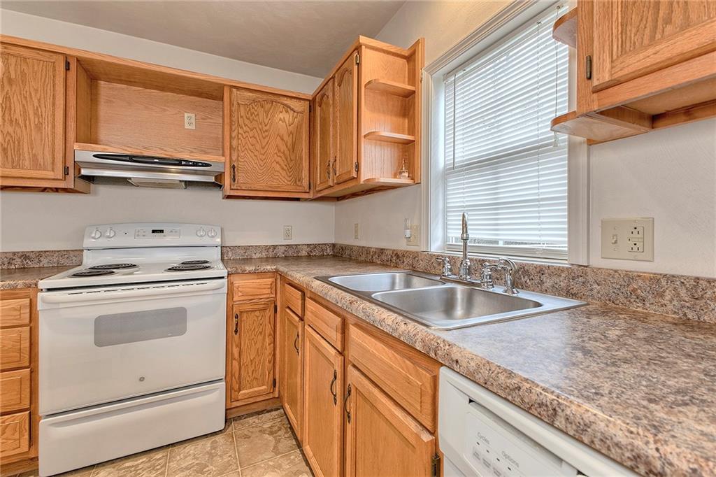 147 South Quarry Street Mount Pleasant, PA 15666 - Photo 25 of 30 a kitchen with granite countertop a sink stove and cabinets