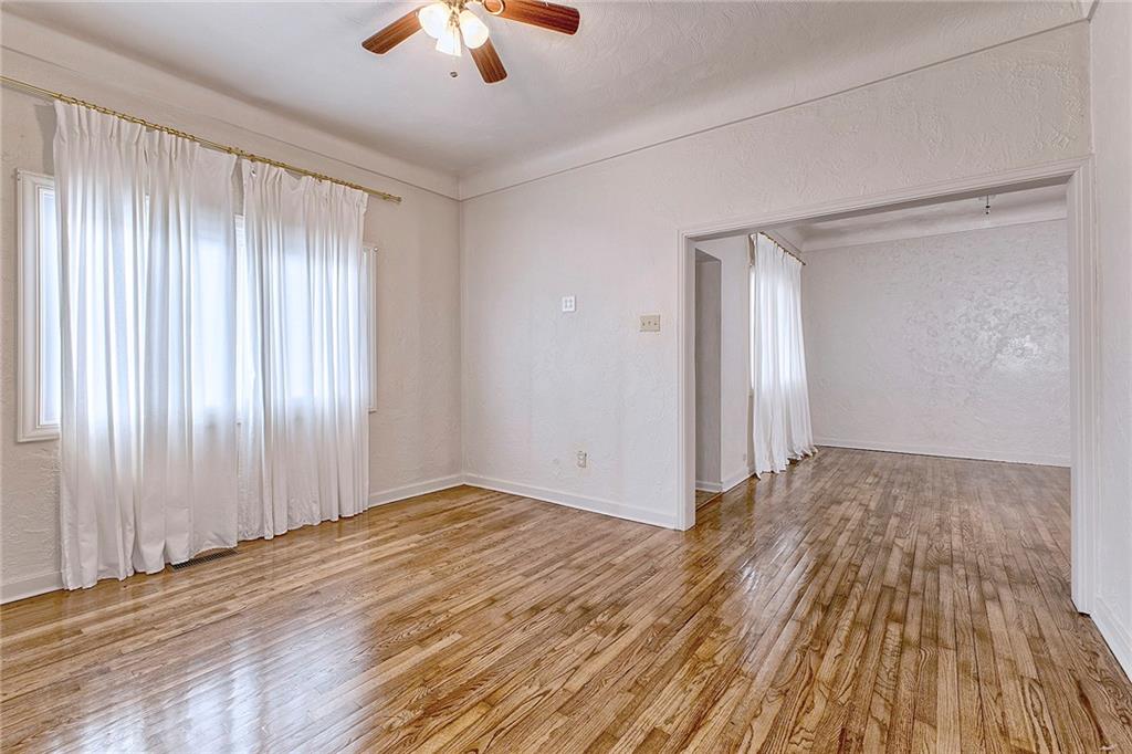 147 South Quarry Street Mount Pleasant, PA 15666 - Photo 7 of 30 an empty room with wooden floor chandelier fan and windows
