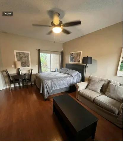 a bedroom with furniture and a large window