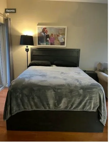 a bedroom with a bed and wall painting