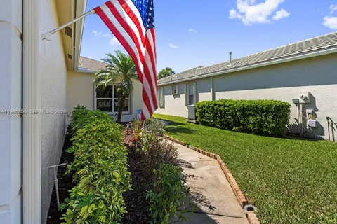 a view of a house with backyard and porch