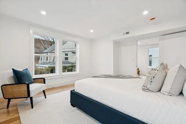 a spacious bedroom with a bed and a couch