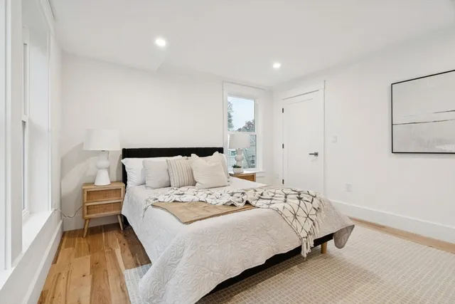 a bedroom with a bed and a night stand