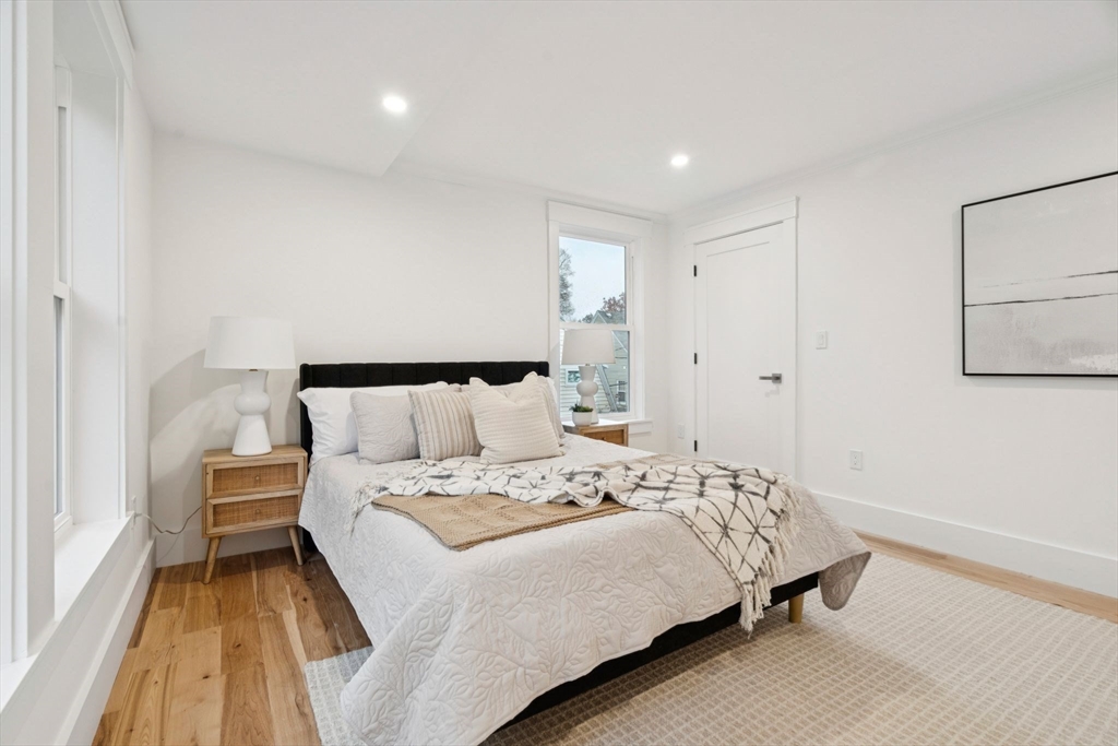 15 Spring Hill Terrace Somerville, MA 02143 - Photo 18 of 38 a bedroom with a bed and a night stand