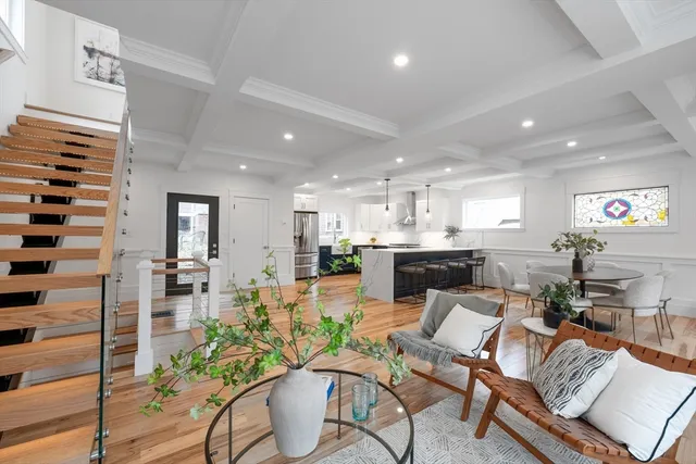 a living room with furniture kitchen and a table