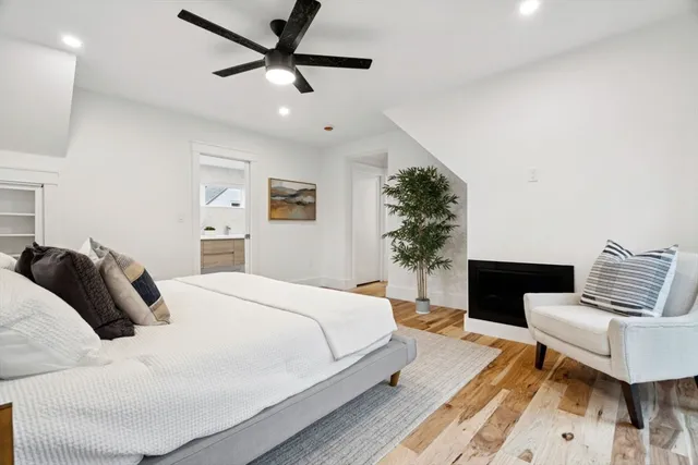 a bedroom with a bed couch and a potted plant