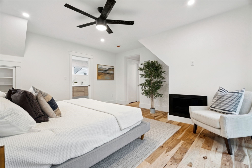 15 Spring Hill Terrace Somerville, MA 02143 - Photo 22 of 38 a bedroom with a bed couch and a potted plant