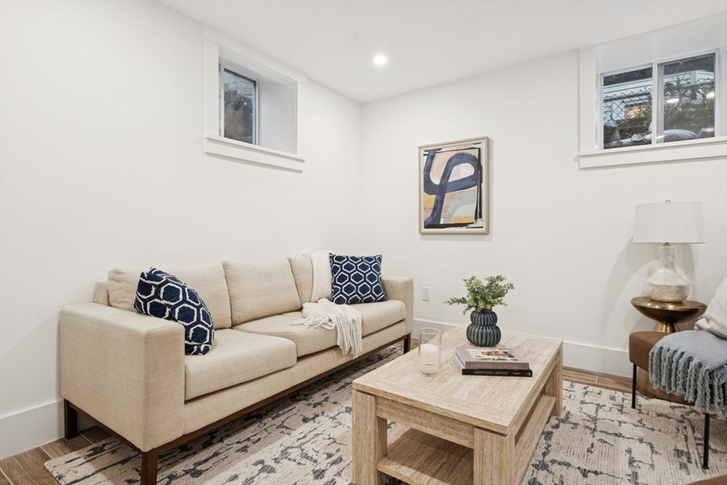 15 Spring Hill Terrace Somerville, MA 02143 - Photo 29 of 38 a living room with furniture and wooden floor