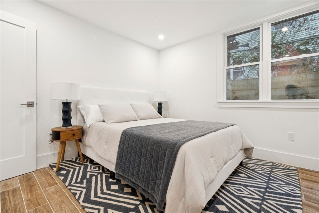 15 Spring Hill Terrace Somerville, MA 02143 - Photo 33 of 38 a bedroom with a bed and wooden floor