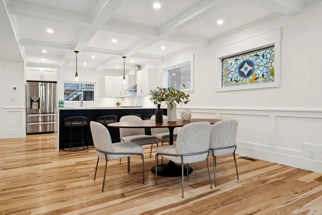 a dining room with furniture and wooden floor