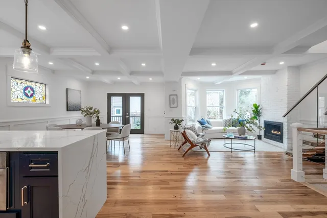 a living room with lots of furniture and kitchen view