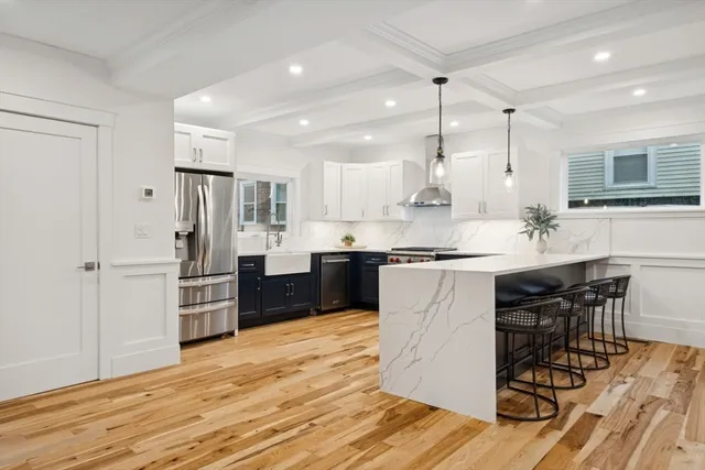 a kitchen with refrigerator cabinets and wooden floor