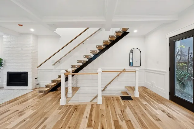 a view of entryway and hall with wooden floor