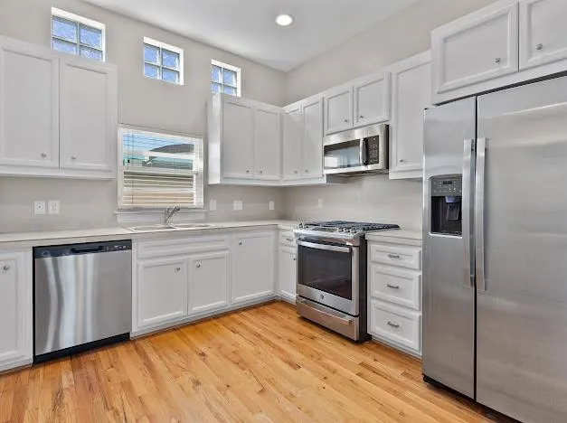 a kitchen with stainless steel appliances a stove sink and refrigerator
