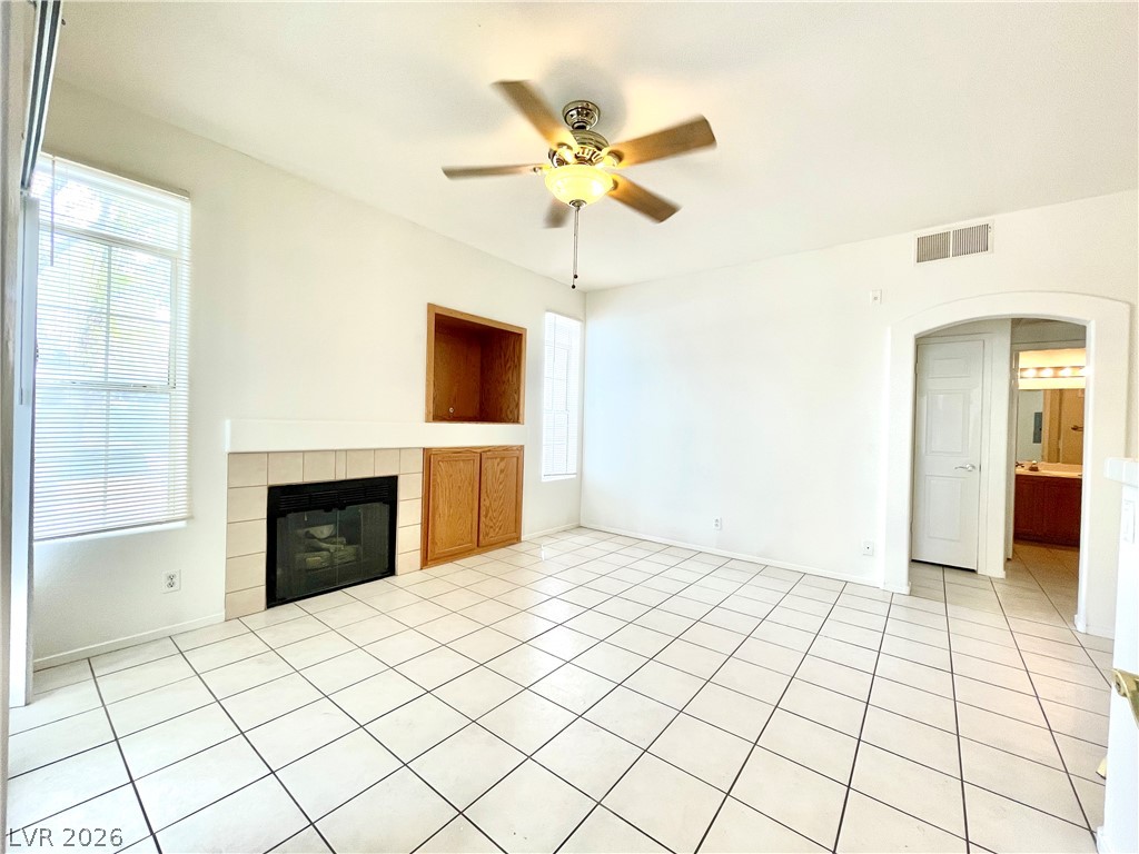 2201 Ramsgate Drive, Unit 915 Henderson, NV 89074 - Photo 16 of 36 A well-lit interior space with a corner fireplace and built-in cabinetry provides practical charm.