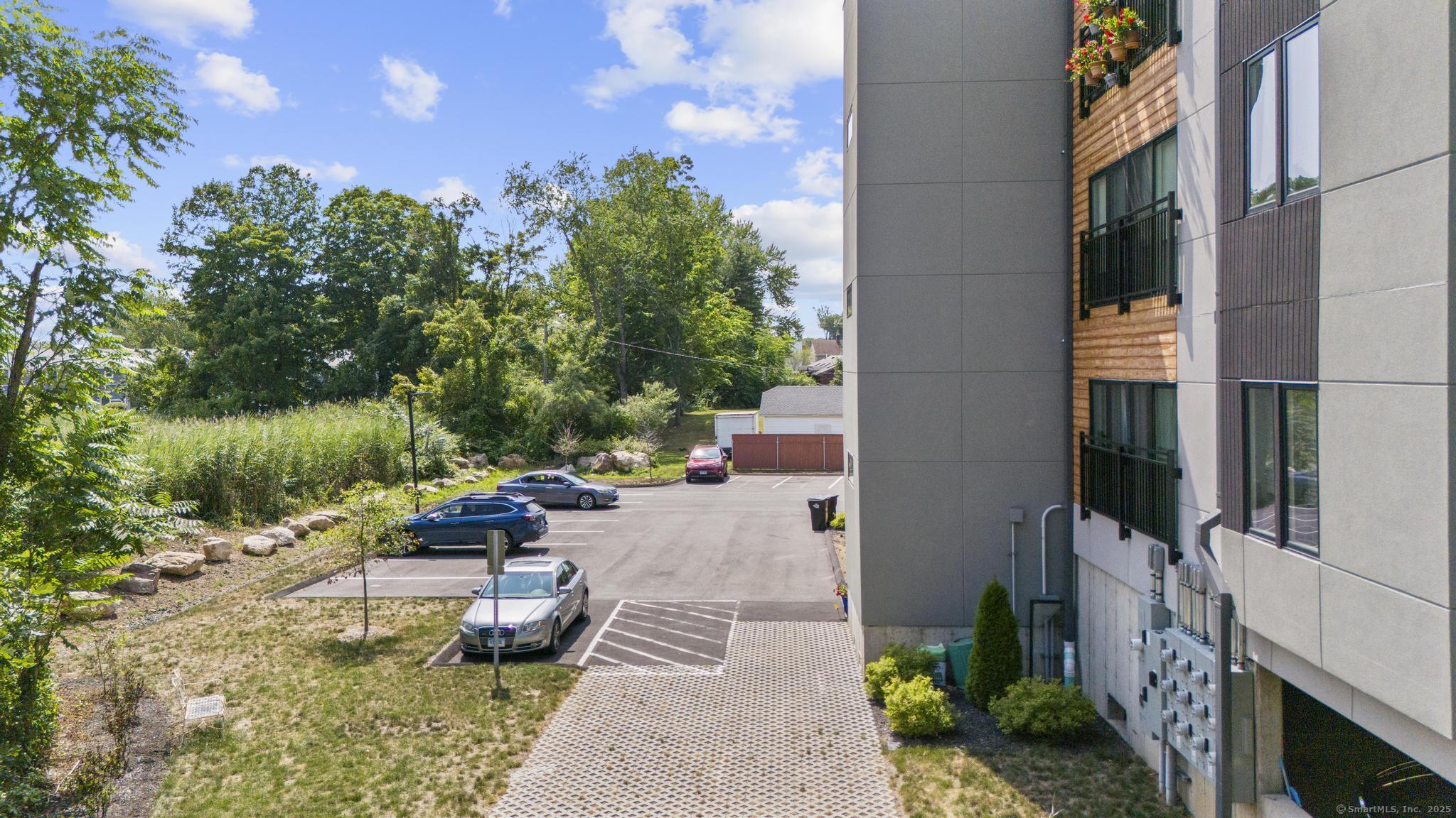 245 East Main Street, Unit 2 Branford, CT 06405 - Photo 12 of 40 a view of a patio with couches and table and chairs and potted plants
