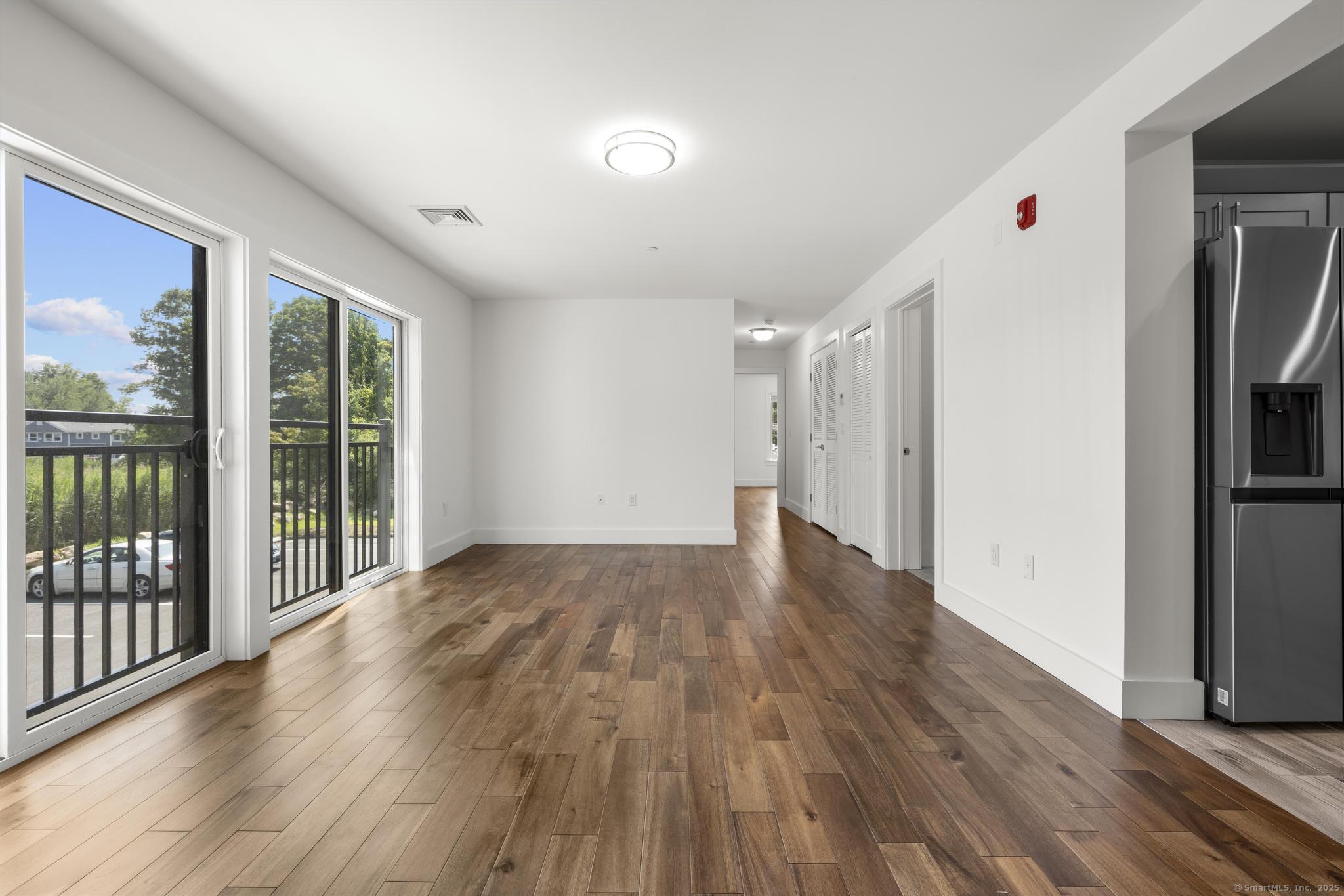 245 East Main Street, Unit 2 Branford, CT 06405 - Photo 15 of 40 a view of livingroom with hardwood floor and hallway
