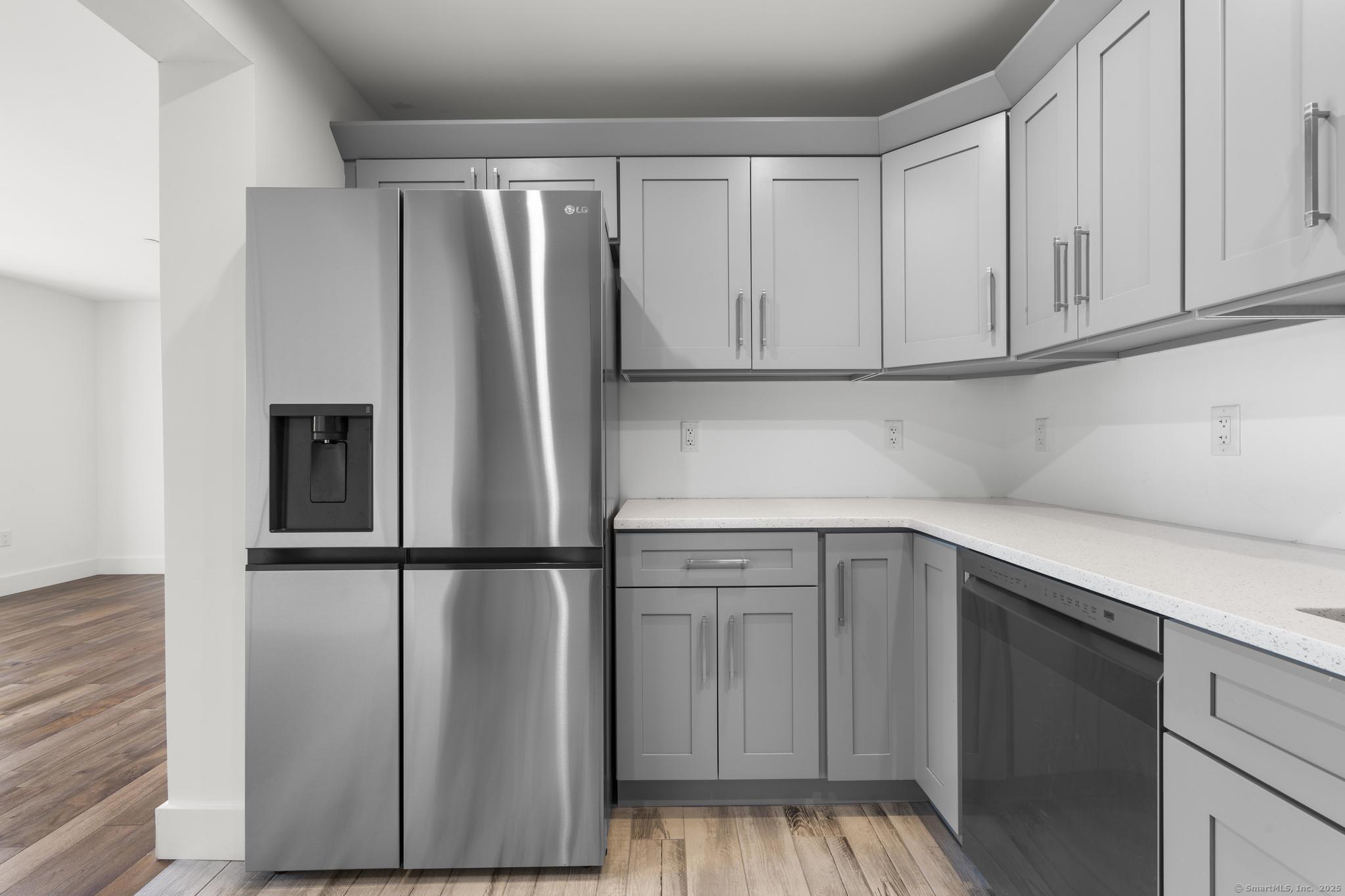 245 East Main Street, Unit 2 Branford, CT 06405 - Photo 26 of 40 a kitchen with stainless steel appliances granite countertop a refrigerator and a sink