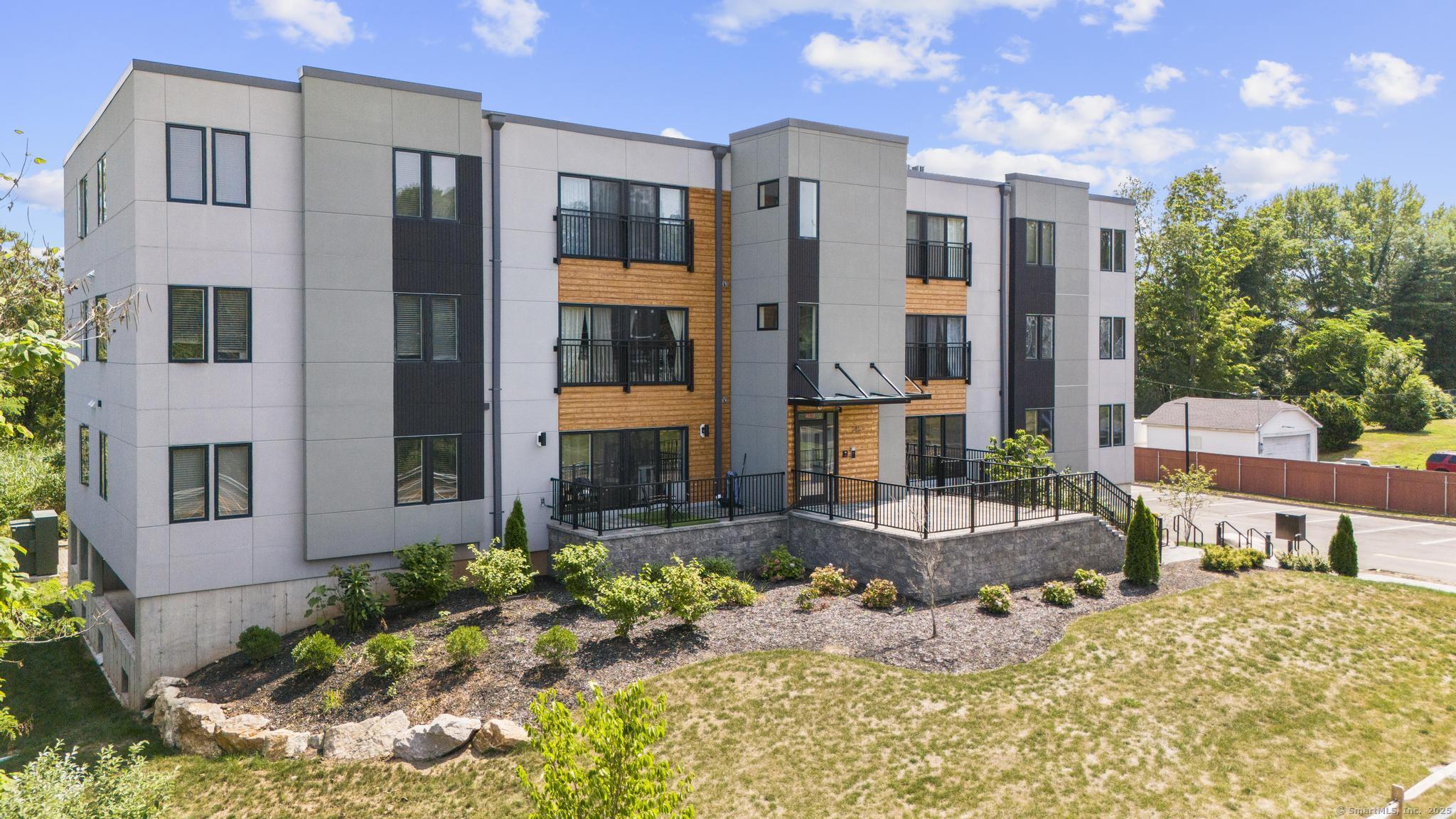 245 East Main Street, Unit 2 Branford, CT 06405 - Photo 3 of 40 a front view of a house with a yard