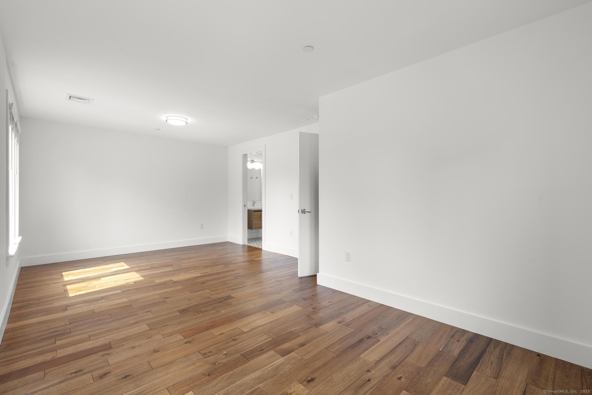 245 East Main Street, Unit 2 Branford, CT 06405 - Photo 37 of 40 a view of an empty room and wooden floor