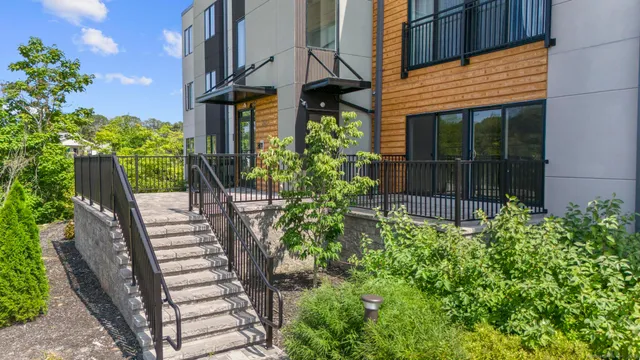 a view of a house with a yard and sitting area