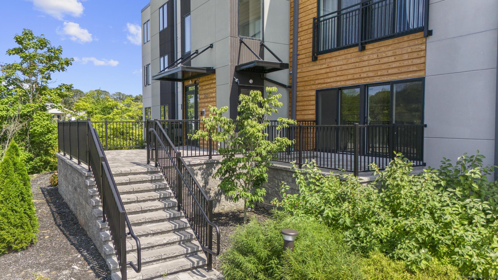 245 East Main Street, Unit 2 Branford, CT 06405 - Photo 6 of 40 a view of a house with a yard and sitting area