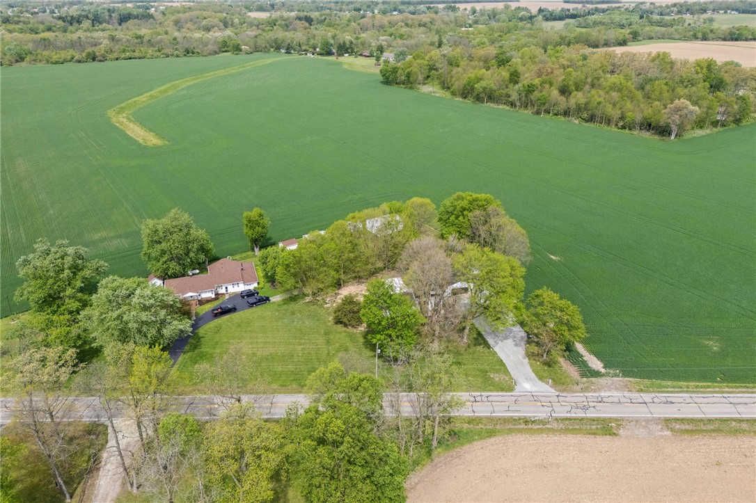 2950 Fairfield Pike Springfield, OH 45502 - Photo 41 of 48 An aerial perspective reveals a residence nestled amidst expansive verdant fields and mature trees.