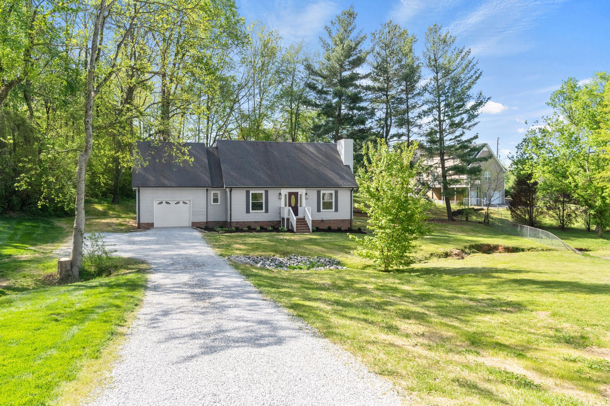 a front view of a house with a yard table and chairs