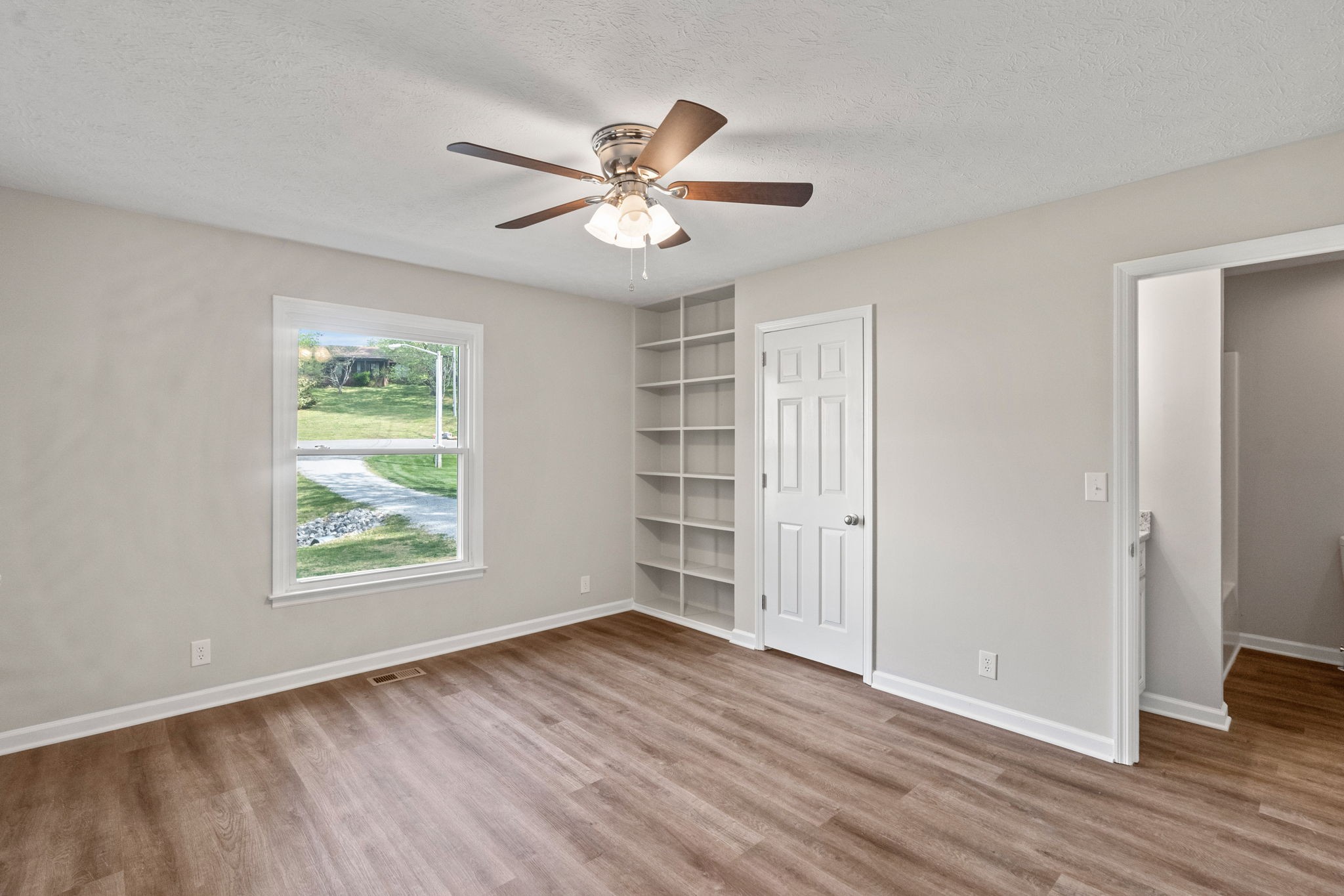 792 Spring Circle Springfield, TN 37172 - Photo 18 of 29 a view of an empty room with a window and wooden floor