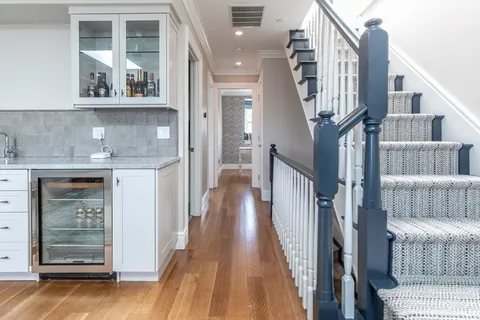 a view of entryway and hall with wooden floor