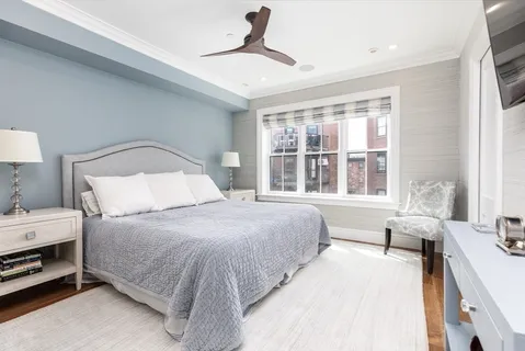 a bedroom with a large bed and a large window