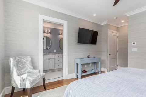 a bedroom with a bed and a television