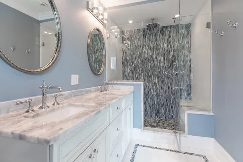 a bathroom with a double vanity sink mirror and shower