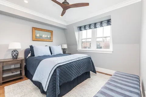 a bedroom with bed and a window