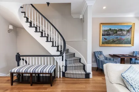 a view of hallway with furniture and wooden floor