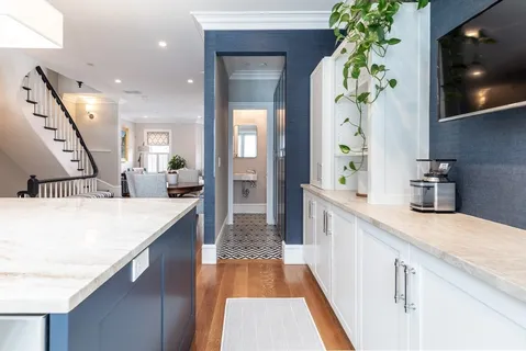 a large kitchen with stainless steel appliances a large counter top