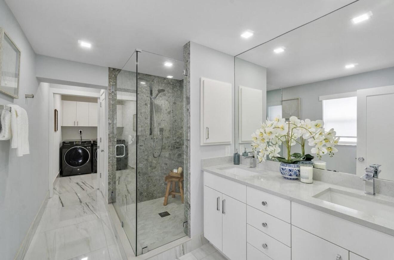 2846 Northeast 35th Court Lighthouse Point, FL 33064 - Photo 11 of 37 a bathroom with a double vanity sink and shower