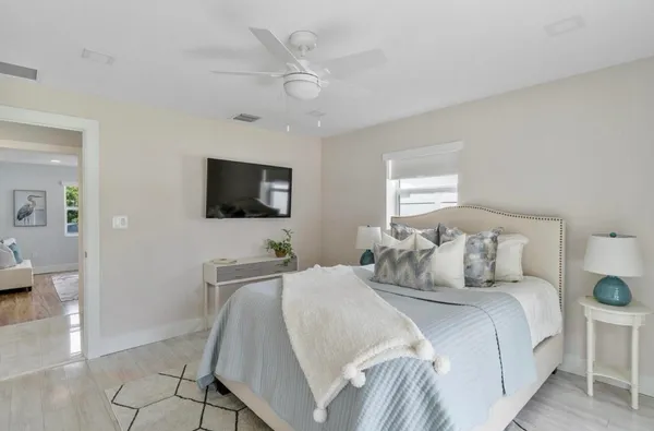 a bedroom with a bed and a flat screen tv