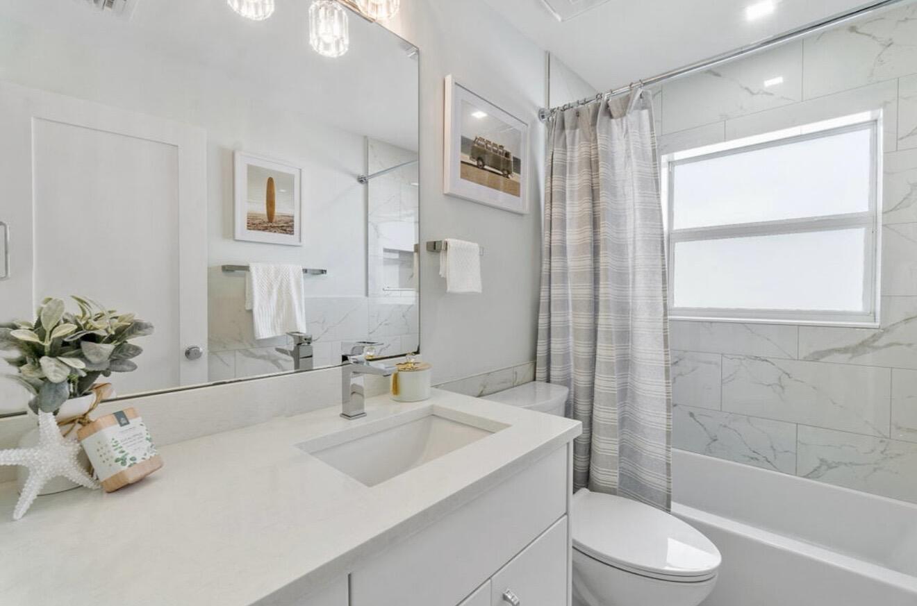 2846 Northeast 35th Court Lighthouse Point, FL 33064 - Photo 13 of 37 a bathroom with a sink a toilet and shower