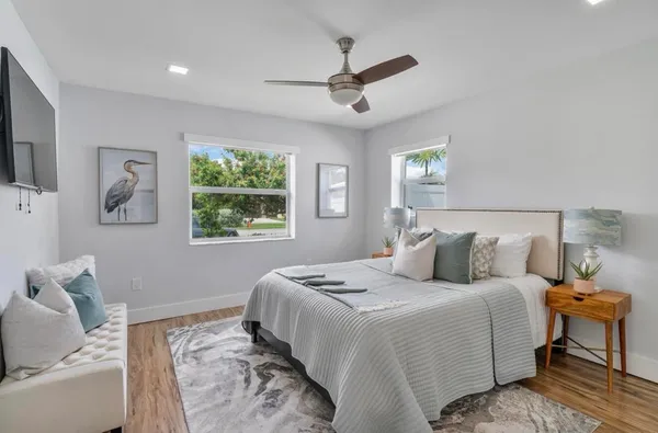 a bedroom with a large bed and a window