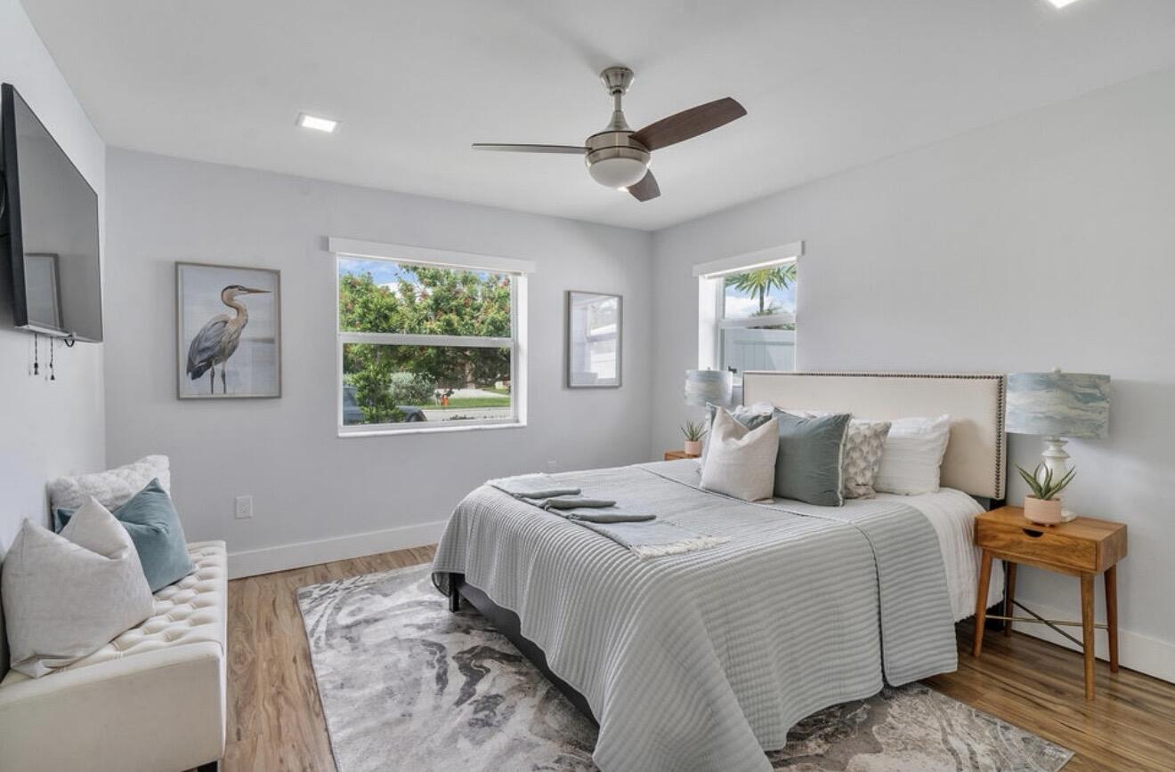 2846 Northeast 35th Court Lighthouse Point, FL 33064 - Photo 14 of 37 a bedroom with a large bed and a window