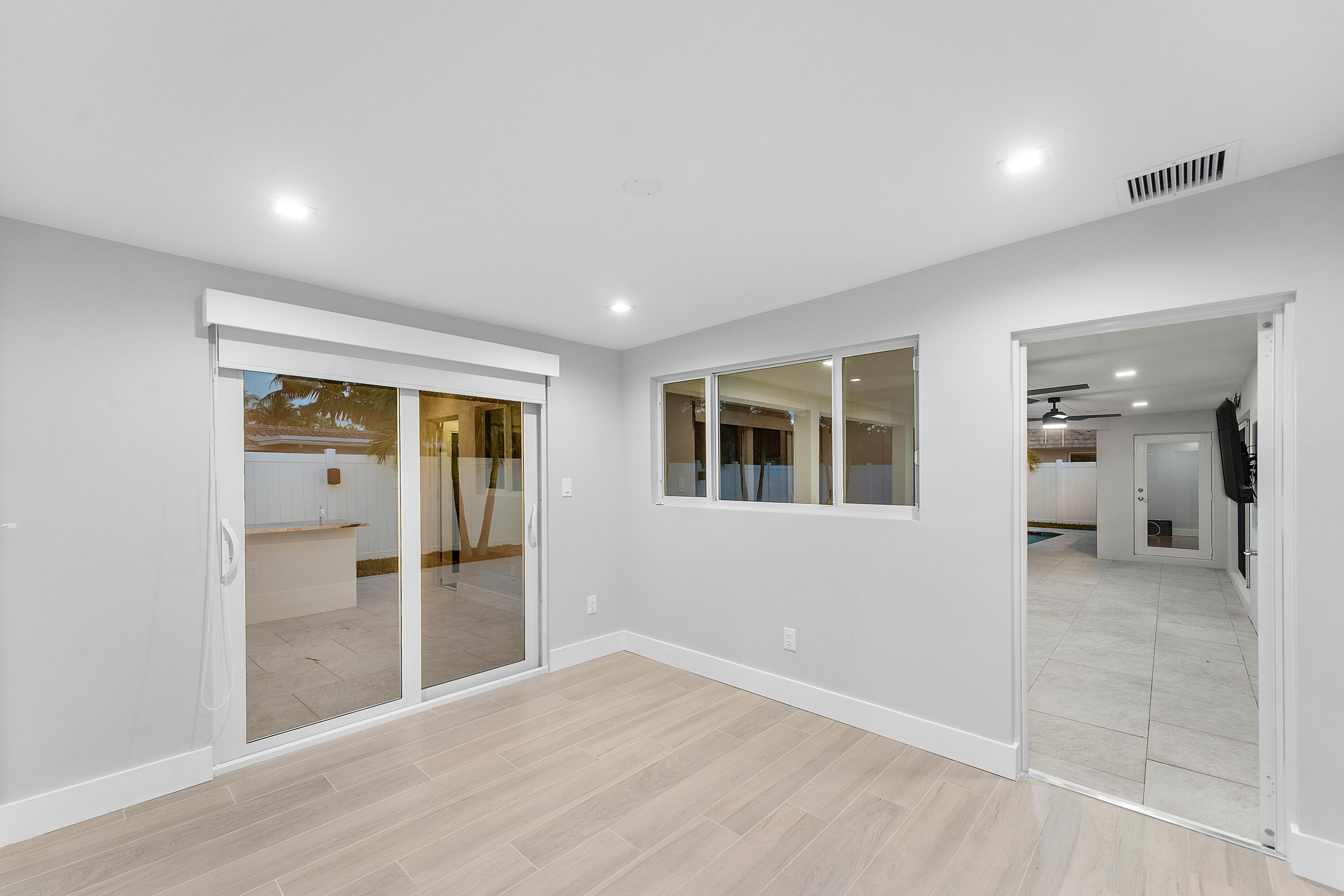 2846 Northeast 35th Court Lighthouse Point, FL 33064 - Photo 15 of 37 wooden floor in an empty room with a window