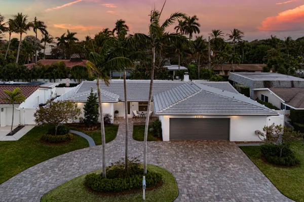 a front view of a house with a yard fire pit and outdoor seating
