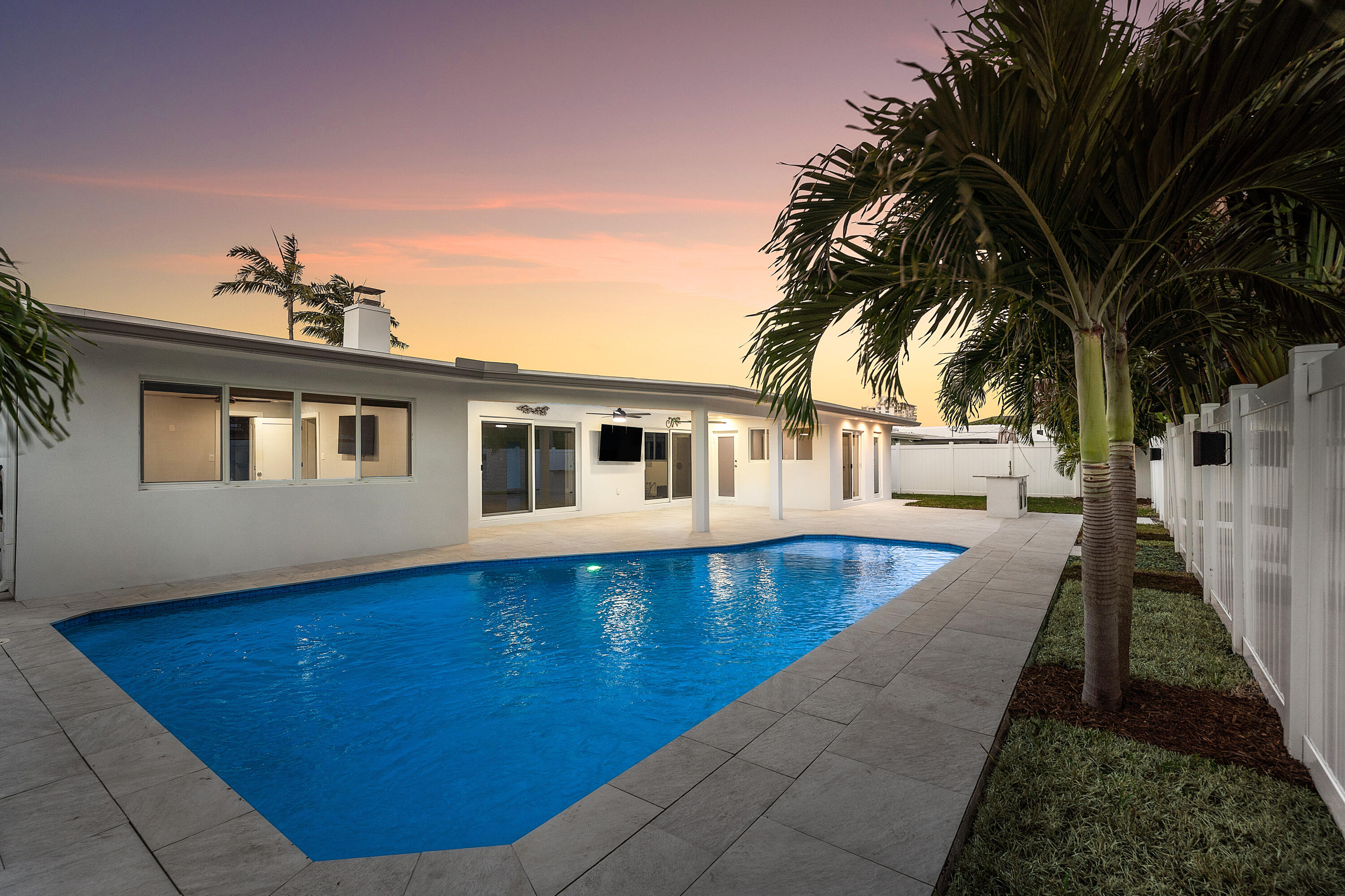 2846 Northeast 35th Court Lighthouse Point, FL 33064 - Photo 3 of 37 a front view of a house with a swimming pool