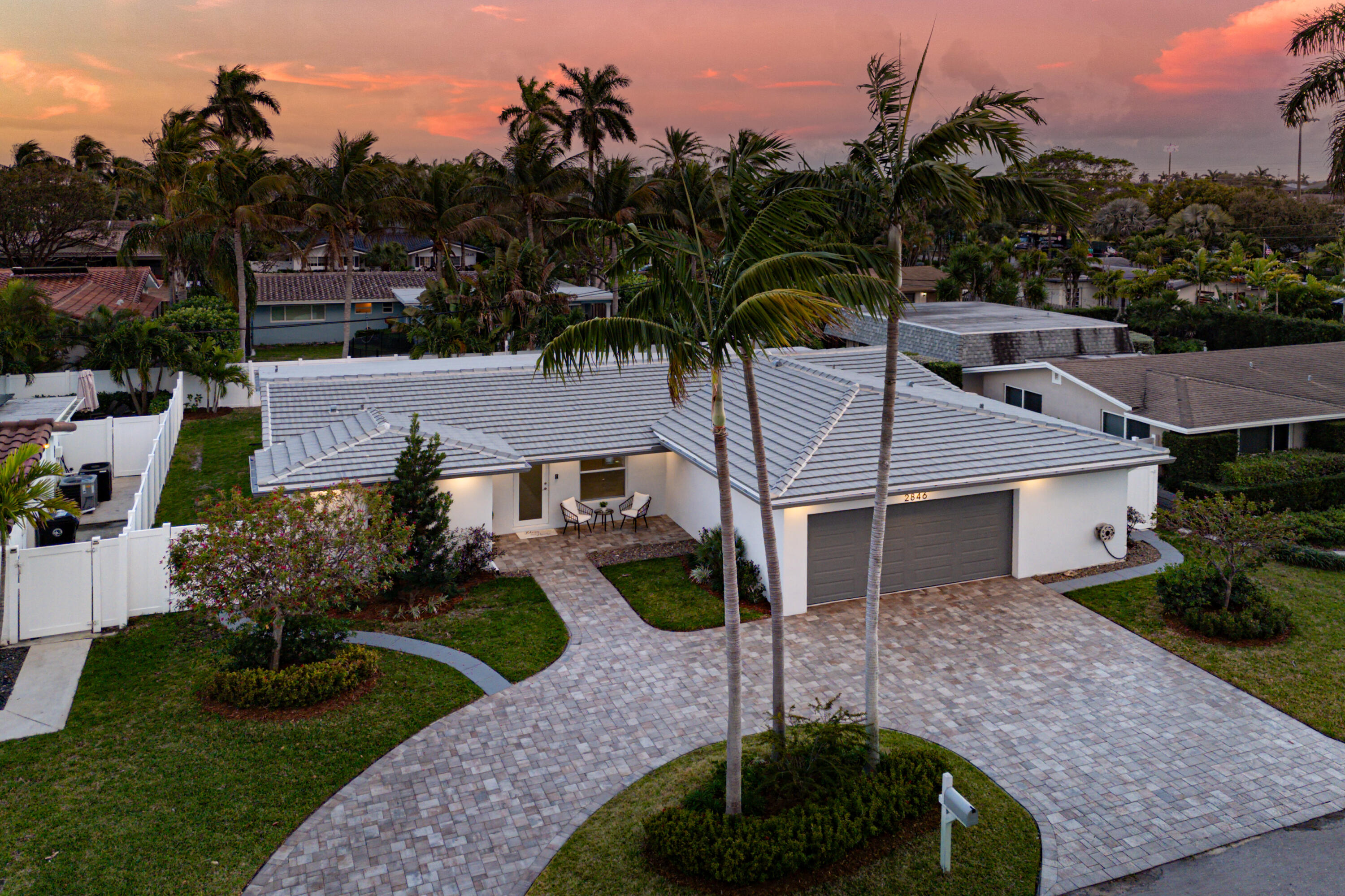 2846 Northeast 35th Court Lighthouse Point, FL 33064 - Photo 31 of 37 a front view of a house with garden