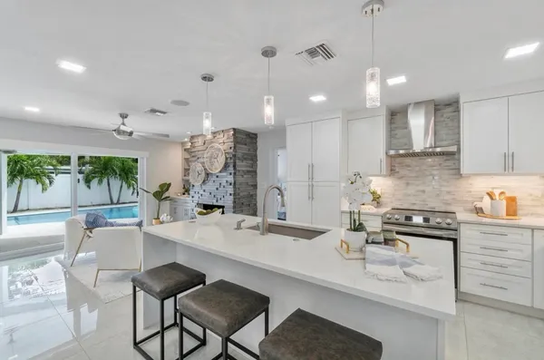 a kitchen with stainless steel appliances kitchen island granite countertop a sink and cabinets