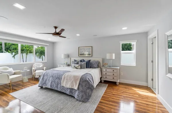 a bedroom with a large bed and a window