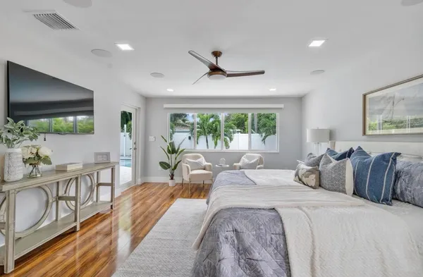 a bedroom with a large bed and a large window