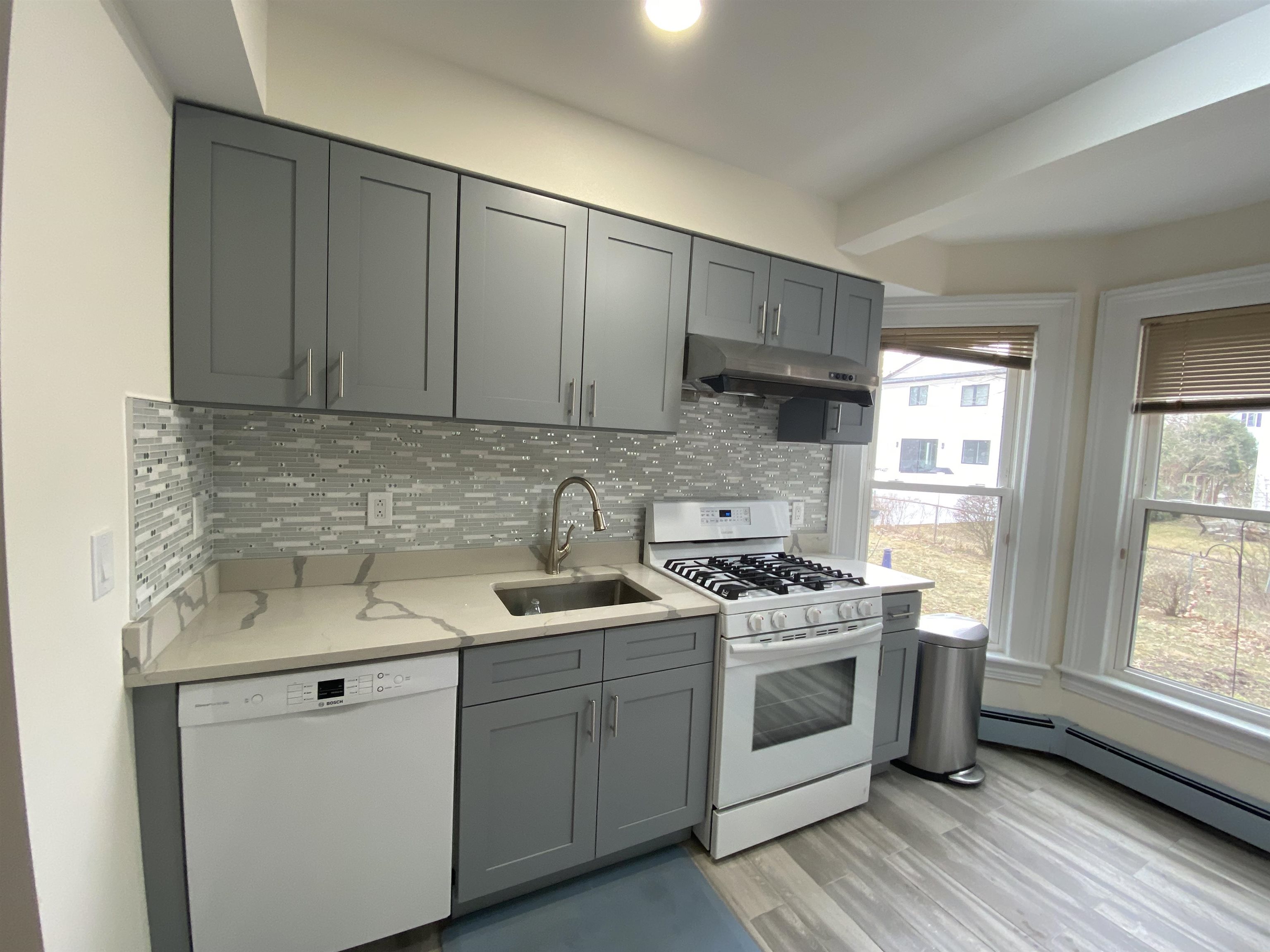 228 Tenafly Road, Unit 1 Tenafly, NJ 07670 - Photo 2 of 10 a kitchen with stainless steel appliances granite countertop a sink stove and cabinets