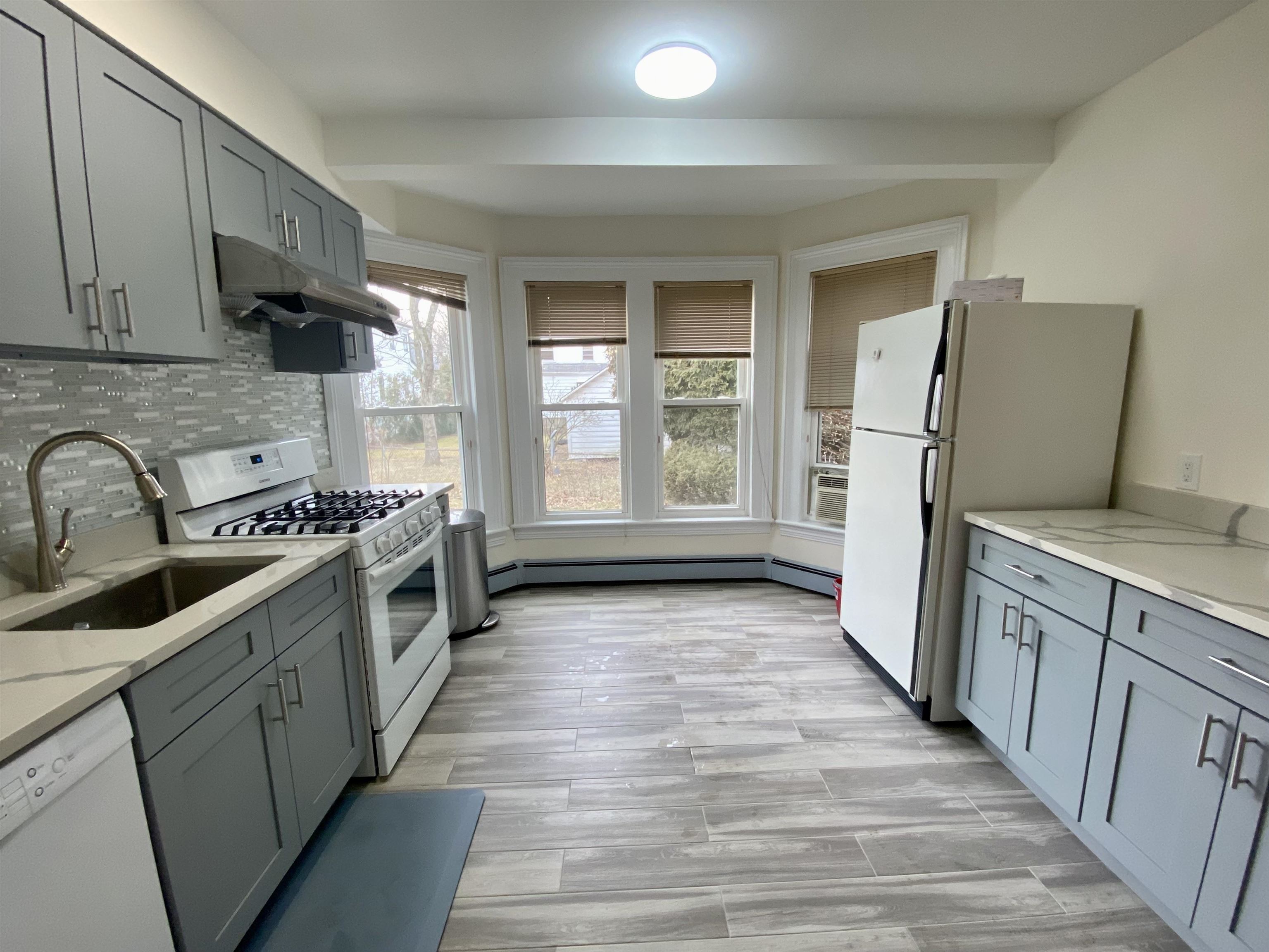 228 Tenafly Road, Unit 1 Tenafly, NJ 07670 - Photo 3 of 10 a kitchen with stainless steel appliances granite countertop a refrigerator and a sink